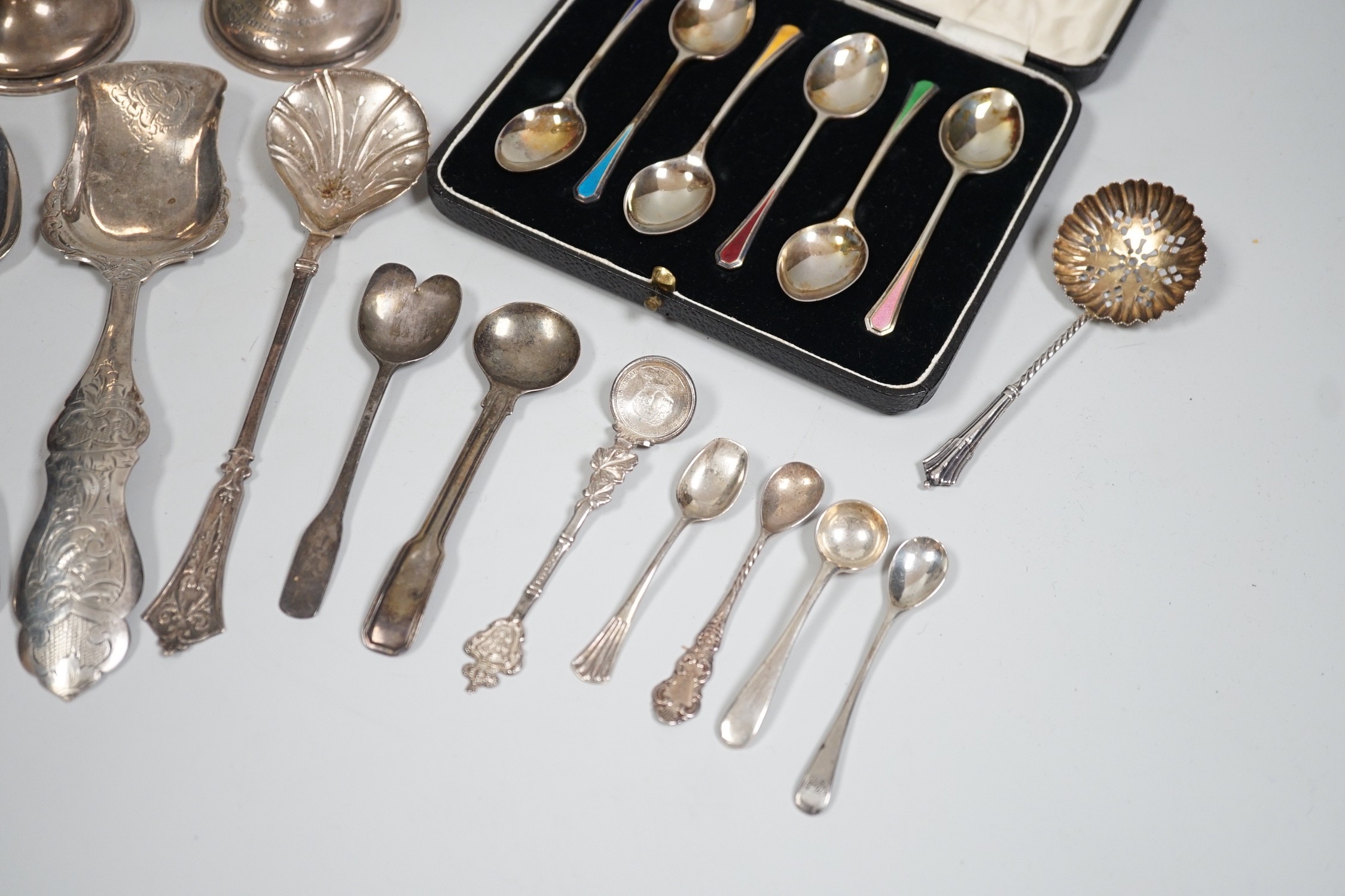 A cased set of six Edwardian silver and enamel teaspoons, William Hair Haseler, Birmingham,1913 and a collection of silver spoons and two silver mounted specimen vases.